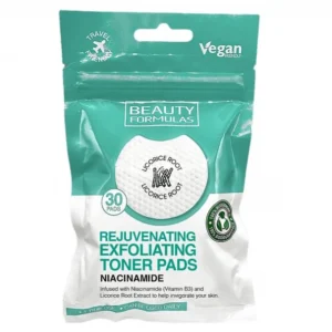 A resealable pouch of Beauty Formulas Rejuvenating Exfoliating Toner Pads against a white background. The packaging features a teal-green top section and a white bottom section. The top teal section includes a "Travel Friendly" logo with an airplane icon on the left, a "Vegan Friendly" logo on the right, and the brand name "BEAUTY FORMULAS" centered inside a white rectangle. A central circular graphic shows a textured white round pad featuring a small icon of licorice sticks and the text "LICORICE ROOT LICORICE ROOT" curved around it. To the left of this circle is a small teal badge reading "30 PADS." The lower white section displays the product name in large, bold teal lettering: "REJUVENATING EXFOLIATING TONER PADS," followed by the text "NIACINAMIDE" in bold black. Below, the description reads, "Infused with Niacinamide (Vitamin B3) and Licorice Root Extract to help invigorate your skin." A circular "100% Biodegradable" logo with a green recycling arrow icon sits on the right side, and a teal banner at the very bottom reads "1 TIME USE • CAN BE USED DAILY