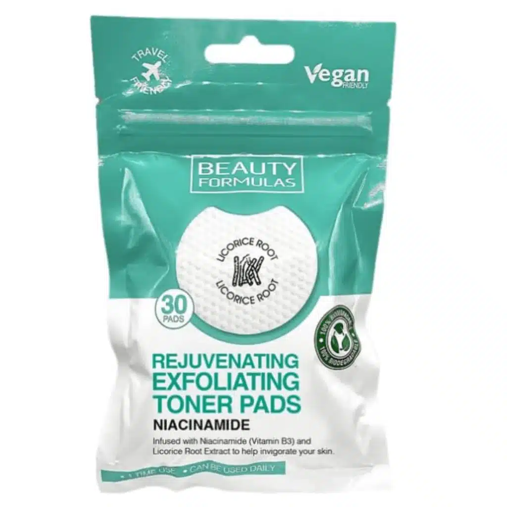 A resealable pouch of Beauty Formulas Rejuvenating Exfoliating Toner Pads against a white background. The packaging features a teal-green top section and a white bottom section. The top teal section includes a "Travel Friendly" logo with an airplane icon on the left, a "Vegan Friendly" logo on the right, and the brand name "BEAUTY FORMULAS" centered inside a white rectangle. A central circular graphic shows a textured white round pad featuring a small icon of licorice sticks and the text "LICORICE ROOT LICORICE ROOT" curved around it. To the left of this circle is a small teal badge reading "30 PADS." The lower white section displays the product name in large, bold teal lettering: "REJUVENATING EXFOLIATING TONER PADS," followed by the text "NIACINAMIDE" in bold black. Below, the description reads, "Infused with Niacinamide (Vitamin B3) and Licorice Root Extract to help invigorate your skin." A circular "100% Biodegradable" logo with a green recycling arrow icon sits on the right side, and a teal banner at the very bottom reads "1 TIME USE • CAN BE USED DAILY