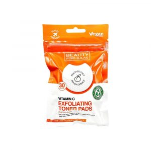 A resealable plastic pouch of Beauty Formulas Vitamin C Exfoliating Toner Pads against a white background. The upper half of the pouch is a bright orange color with "Travel Friendly" and "Vegan Friendly" logos near the top hang hole. The lower half of the pouch is white, featuring bold orange text that reads "VITAMIN C EXFOLIATING TONER PADS" alongside a small description note about peach extract. A circular cutout image in the center showcases a textured, white round pad labeled with a "Peach Extract" peach icon, while badges on the label indicate it contains "30 PADS" and is "100% Biodegradable.